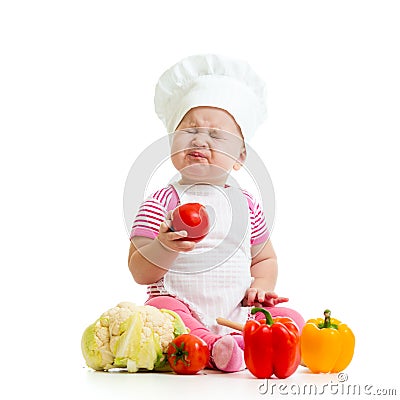 Funny baby weared as cook with vegetables Stock Photo