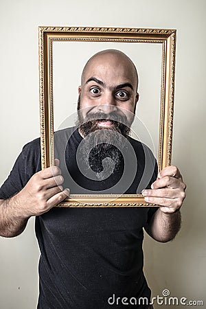 Funny bearded man with golden frame Stock Photo