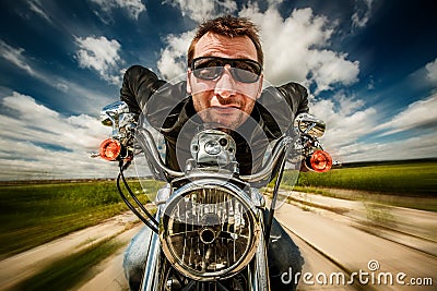 Funny Biker racing on the road Stock Photo