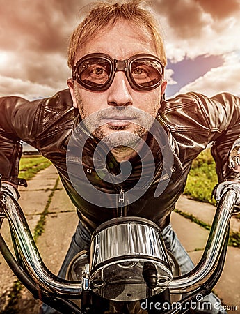 Funny Biker racing on the road Stock Photo