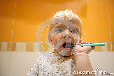 Funny blonde baby child brushing teeth Stock Photo