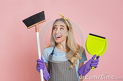 Funny blonde is engaged house cleaning with broom Stock Photo