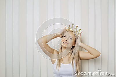 Funny blonde girl i with crown on her head smiling Stock Photo
