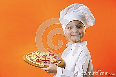 Funny boy chef cooked pizza on a board Stock Photo