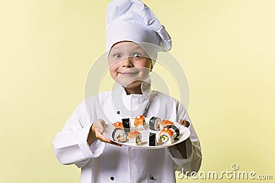 Funny boy chef cooked sushi on a plate Stock Photo