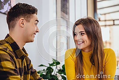 Funny boy and girl spending time in cafe, joking and laughing desparately. Stock Photo