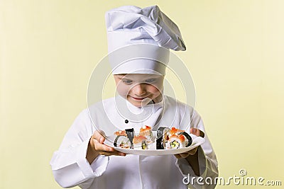 Funny boy chef cooked sushi on a plate Stock Photo