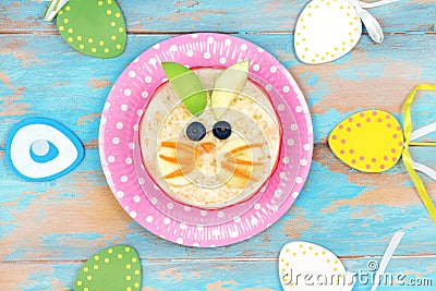 Funny breakfast for kids. oatmeal with fruits. blue wooden background, top view. Easter breakfast idea for children Stock Photo
