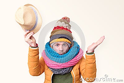 Funny caucasian man in several winter hats ans scarfs welcoming you. Stock Photo