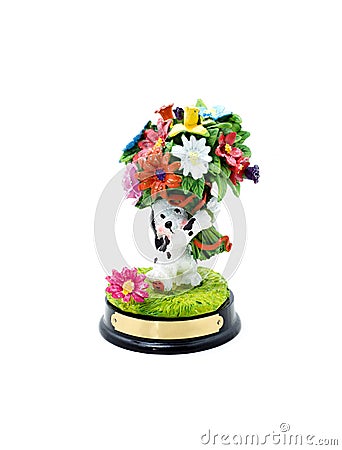 Funny ceramic dog with flowers on a white background. Stock Photo