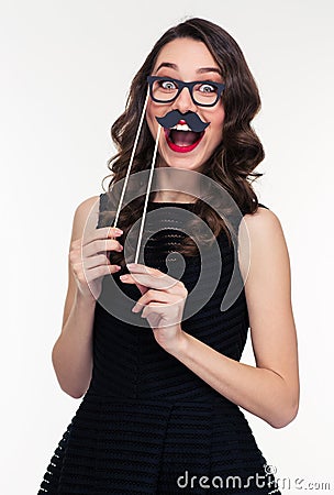 Funny cheerful woman having fun using glasses and moustache props Stock Photo
