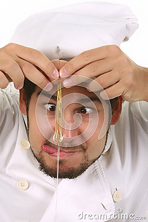 Funny chef cracking an egg Stock Photo