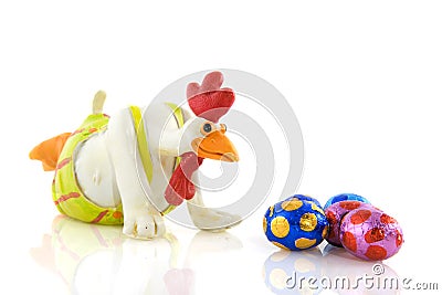 Funny chicken looks to easter eggs Stock Photo