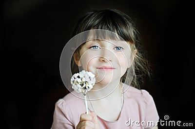 Funny child girl showing a marshmallow cake Stock Photo