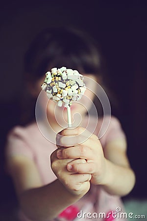 Funny child girl showing a marshmallow cake Stock Photo