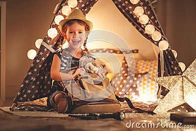 funny child girl tourist with flashlight and world map and backpack Stock Photo