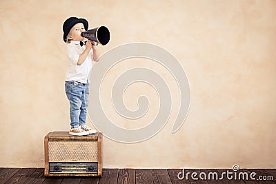 Funny child playing with black retro megaphone Stock Photo