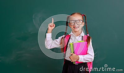 Funny child schoolgirl girl student with book about school blackboard Stock Photo