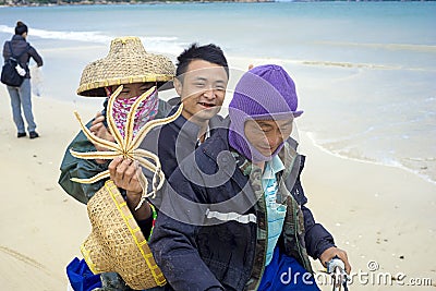 Funny Chinese fishermen on the motorcycle in Troy Editorial Stock Photo