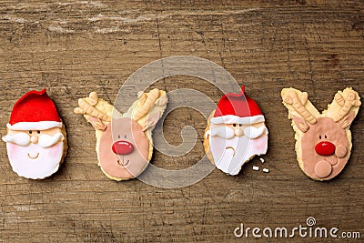 Funny christmas cookies santa and reindeer on wood background Stock Photo