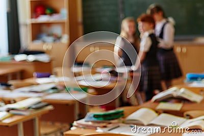 Funny classmates. Three cute little children communicate and discuss something standing near the blackboard . Background image Stock Photo