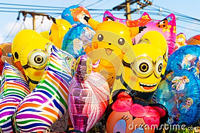 Funny colored balloons in the form of cartoon characters. Joy for the baby Editorial Stock Photo