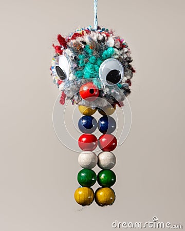 Funny colorful abstract animal made of wool and beads by a child Stock Photo