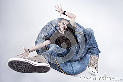 Funny crazy man dressed in jeans and sneakers Stock Photo