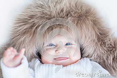 Funny cute baby girl wearing huge winter hat Stock Photo