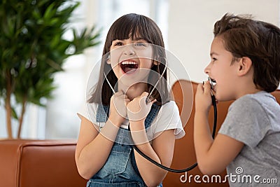 Funny cute children siblings playing doctor having fun at home Stock Photo