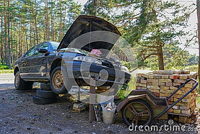 A fun car repair method in a rural area Stock Photo