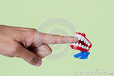 Funny denture biting a finger Stock Photo