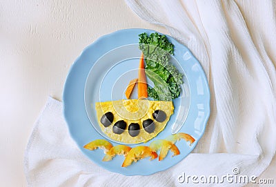 Funny dish for Kids. Omelette with vegetables. Creative idea of breakfast. Restaurant menu. Food art. Stock Photo