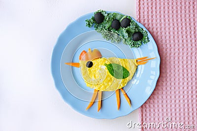 Funny dish for Kids. Omelette with vegetables in shape of chicken. Food art. Creative breakfast. Healthy lifestyle. Stock Photo