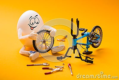 Funny egg repairing wheel Stock Photo