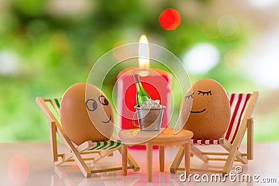 Funny eggs on a beach chair relaxing Stock Photo