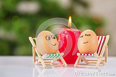Funny eggs on a beach chair relaxing Stock Photo