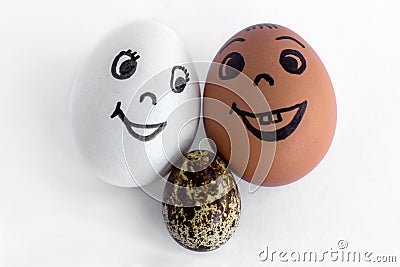 Funny eggs imitating a smiling mixed couple with versicolored ba Stock Photo