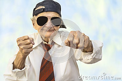 Funny elderly woman wearing cap in a fight pose. Stock Photo