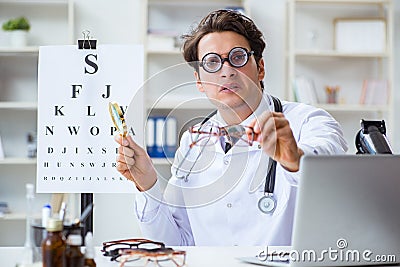 The funny eye doctor in humourous medical concept Stock Photo