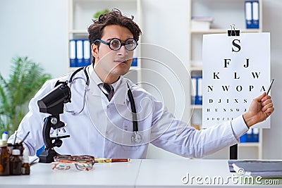 The funny eye doctor in humourous medical concept Stock Photo