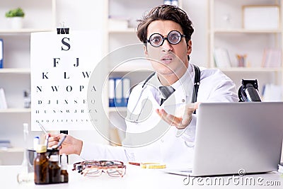 The funny eye doctor in humourous medical concept Stock Photo