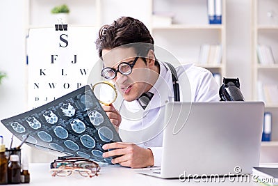 The funny eye doctor in humourous medical concept Stock Photo