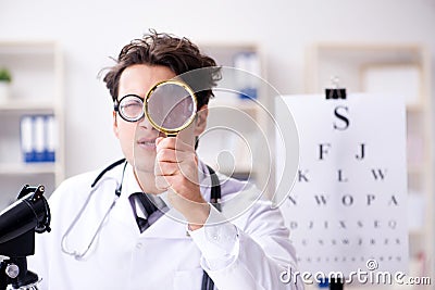 The funny eye doctor in humourous medical concept Stock Photo