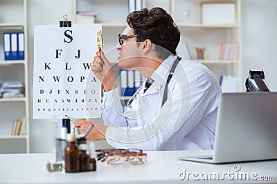 The funny eye doctor in humourous medical concept Stock Photo