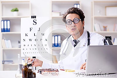 The funny eye doctor in humourous medical concept Stock Photo