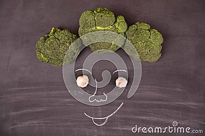 Funny face from vegetables on black ground Stock Photo