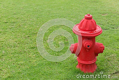 Red Fire hydrant on green grass field Stock Photo