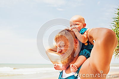 Funny family photo. Baby son sit on father shoulders. Stock Photo