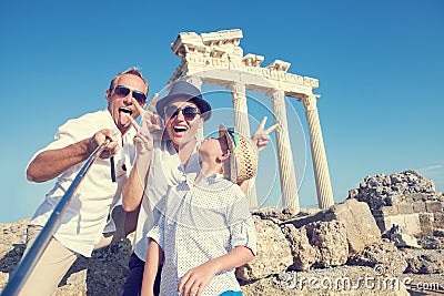 Funny family take a selfie photo on Apollo Temple colonnade view Stock Photo